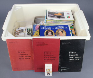 A white plastic crate containing a collection of tea cards