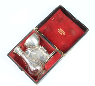 A Victorian silver travelling communion set comprising challis, paten and oil bottle, Birmingham 1894, weighable silver 138 grams, cased 