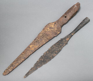 A corroded leaf shaped spear head 44cm x 7cm together with 1 other 36cm x 4cm