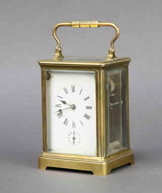 A French 8 day carriage alarm clock with enamelled dial, Roman numerals and alarm dial, contained in a gilt metal case complete with key 13cm x 10cm x 8cm 