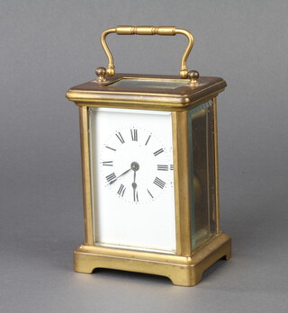 A 19th Century French carriage timepiece with enamelled dial and Roman numerals contained in a gilt case