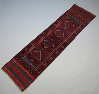 A red and blue ground Meshwani runner with 4 diamonds to the centre within a multi row border 243cm x 68cm 