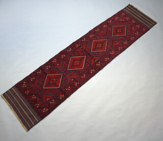 A red and blue ground Meshwani runner with 4 diamonds to the centre 263cm x 63cm 