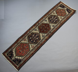 A blue and white ground Persian runner with 5 diamonds to the centre 280cm x 78cm 