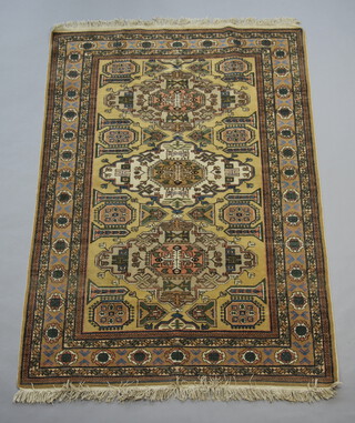 A Caucasian style rug with 3 medallions to the centre within a multi row border 196cm x 137cm 