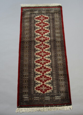 A red and brown ground Bokhara runner with 10 stylised diamonds to the centre within a multi row border 192cm x 79cm 