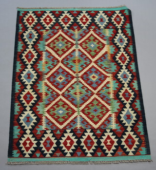A white, green and turquoise ground Chobi Kilim rug with overall geometric design 146cm x 109cm 