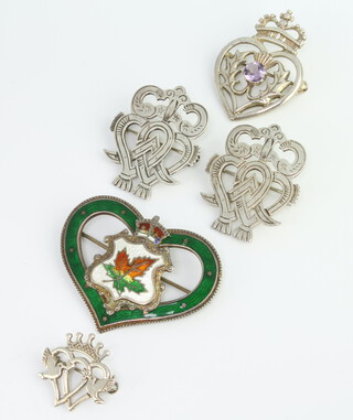 Four Scottish silver brooches together with a sterling silver enamelled Canadian brooch gross 34 grams