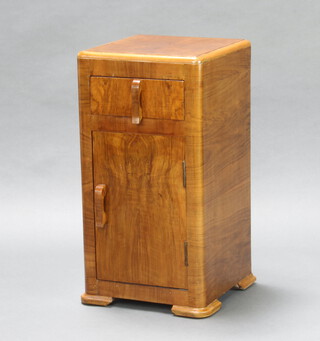 An Art Deco figured walnut bedside cabinet fitted a drawer above panelled door 69cm h x 35cm w x 36cm d  