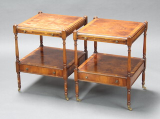 A pair of Georgian style quarter veneered and crossbanded figured walnut square 2 tier lamp tables, fitted brushing slide and drawer, raised on brass caps and casters 59cm h x 46cm w x 46cm d 