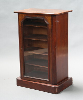 A Victorian inlaid walnut music cabinet with shelved interior enclosed by a shaped glazed panelled door, raised on a platform base 80cm h x 52cm w x 33cm d 