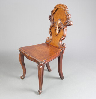 A Victorian carved mahogany hall chair with shaped back with and solid seat, raised on cabriole supports 89cm h x 40cm w x 42cm d (seat 30cm x 30cm) 