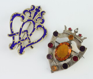 A Scottish shield shaped hardstone brooch, an enamelled ditto 