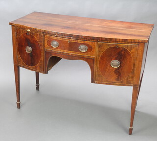 A Georgian inlaid mahogany bow front sideboard fitted a drawer flanked by cupboard and 1 short drawer, raised on square tapered supports, spade feet 92cm h x 123cm w x 61cm d 