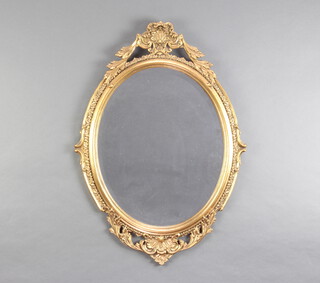 An oval bevelled plate wall mirror contained in a decorative gilt frame with swag decoration 76cm h x 54cm w 