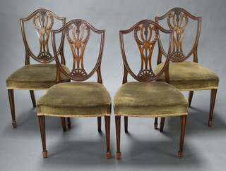 A set of 4 19th Century Hepplewhite style camel back dining chairs, the pierced shield backs with carved ears of corn and over stuffed seats, raised on square tapered supports  