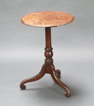 A circular mahogany and oak wine table raised on pillar and tripod base 73cm h x 51cm diam. 