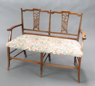 An Edwardian double chair back settee with vase shaped slat back and upholstered seat, raised on square supports 88cm h x 111cm w x 47cm d (seat 90cm w x 38cm d) 