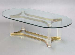 A mid Century gilt metal perspex and plate glass oval coffee table, raised on a shaped base 41cm h x 135cm l x 70cm d 