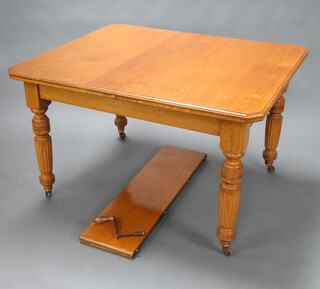 A Victorian light oak extending dining table raised on turned and reeded supports with one extra leaf and winder. 76cm h x 108cm w x 123cm l. (when leaf in 152cm l)