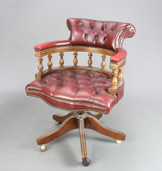 A Captain's style mahogany framed revolving office chair upholstered in red buttoned material 82cm h x 62cm w x 54cm d (seat 41cm x 37cm) 
