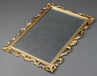 A rectangular bevelled plate wall mirror contained in a decorative gilt frame 77cm  x 52cm 