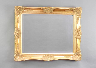A rectangular bevelled plate wall mirror contained in a decorative gilt frame 62cm x 76cm 