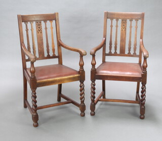 A pair of 1920's oak stick and rail back open arm carver chairs with upholstered drop in seats, raised on spiral turned supports 102cm h x 56cm w x 54cm d (seat 30cm x 31cm) 