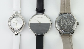 A lady's Swarovski Crystal wristwatch, a gentleman's ditto and a Calvin Klein wristwatch 