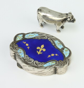 A Continental 800 standard enamelled pill box decorated with a fleur de lis 5cm, 24 grams together with a white metal figure of a cow 3.5cm 