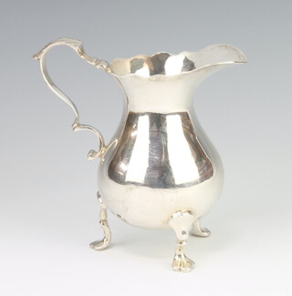 A Georgian design baluster silver cream jug with S scroll handle on scroll feet London 1934, 110 grams, 9cm 