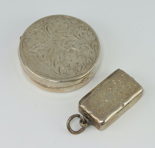 A Victorian silver vinaigrette engraved with scrolls, London 1858, 3cm together with a circular silver pill box 26 grams