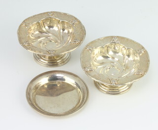 A pair of Edwardian repousse silver pedestal bon bon dishes Birmingham 1906 6cm, together with a Continental dish 10 grams 