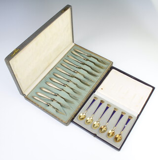 A set of 6 Danish Sterling silver and enamel gilt spoons with coronet handles, cased, 64 grams (1 is chipped) together with a cased set of 6 pairs of Continental silver eaters 