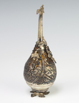 An Eastern repousse white metal rosewater bottle decorated with a bird and flowers 116 grams, 15cm 