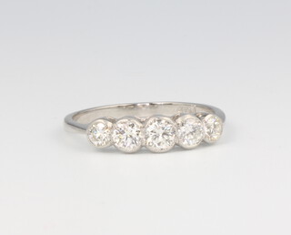 A platinum 5 stone graduated diamond ring, approx 0.70ct 2.7 grams, size N 1/2