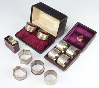 A set of 4 cased Victorian silver napkin rings Birmingham 1875, 7 others, 236 grams 