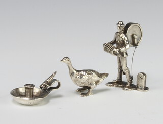 A silver figure of a street musician 5.5cm, a goose and a chamberstick 72 grams