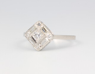 A platinum diamond ring with centre old cut stones, surrounded by baguette and brilliant cut diamonds 0.45ct, 3.6 grams, size O 