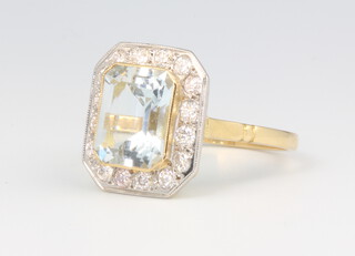 An 18ct yellow gold aquamarine and diamond cluster ring, the centre stone approx. 2.5ct surrounded by brilliant cut diamonds 0.5ct, size O, 4.4 grams