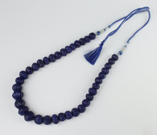 A strand of graduated carved blue hardstone beads 38cm 