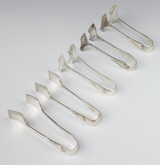 Five pairs of silver plated lily pattern sardine tongs 