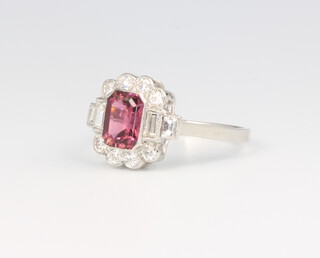 A platinum pink tourmaline and diamond cluster ring, the centre stone surrounded by brilliant and baguette cut diamonds, the tourmaline 0.85ct, diamonds 0.5ct, size N, 4.1 grams 