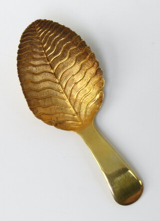 A Georgian silver gilt caddy spoon with leaf bowl, rubbed marks, 9 grams 