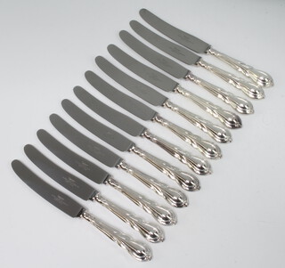 Twelve silver plated lily pattern cake knives 