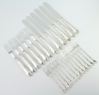 Twelve silver plated lily pattern 3 pronged forks together with a set of 6 dessert eaters 