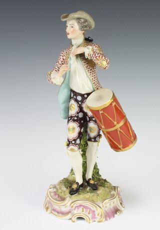 A Samson 19th Century figure of a standing gentleman carrying a drum, raised on a rococo base 30cm 

