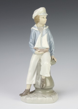 A Lladro figure of a boy sailor sitting on a capstan 23cm 