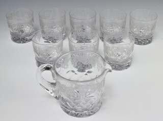 Eight cut glass tumblers decorated with grapes and vines together with a a water jug 