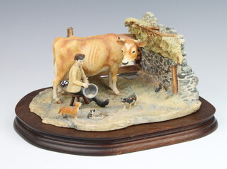 A Border Fine Arts group of cow, milkman and kittens in a barn by Ayres 19cm, on a wooden base